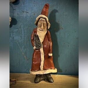 Primitive Santa holding tree